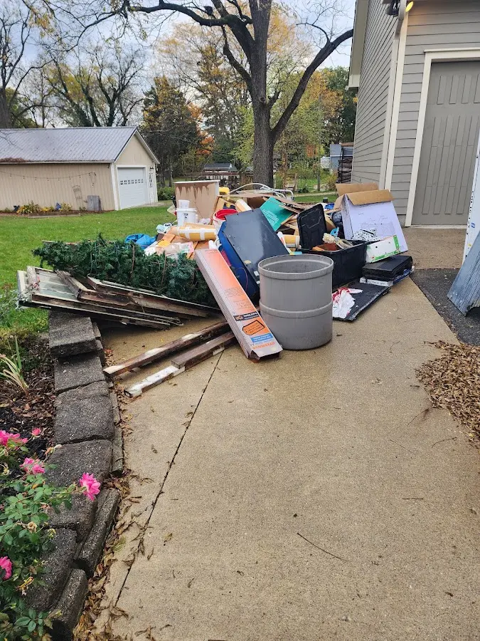 Dumpster being loaded with debris for 12 Yard Dumpster Rental in White Oak
